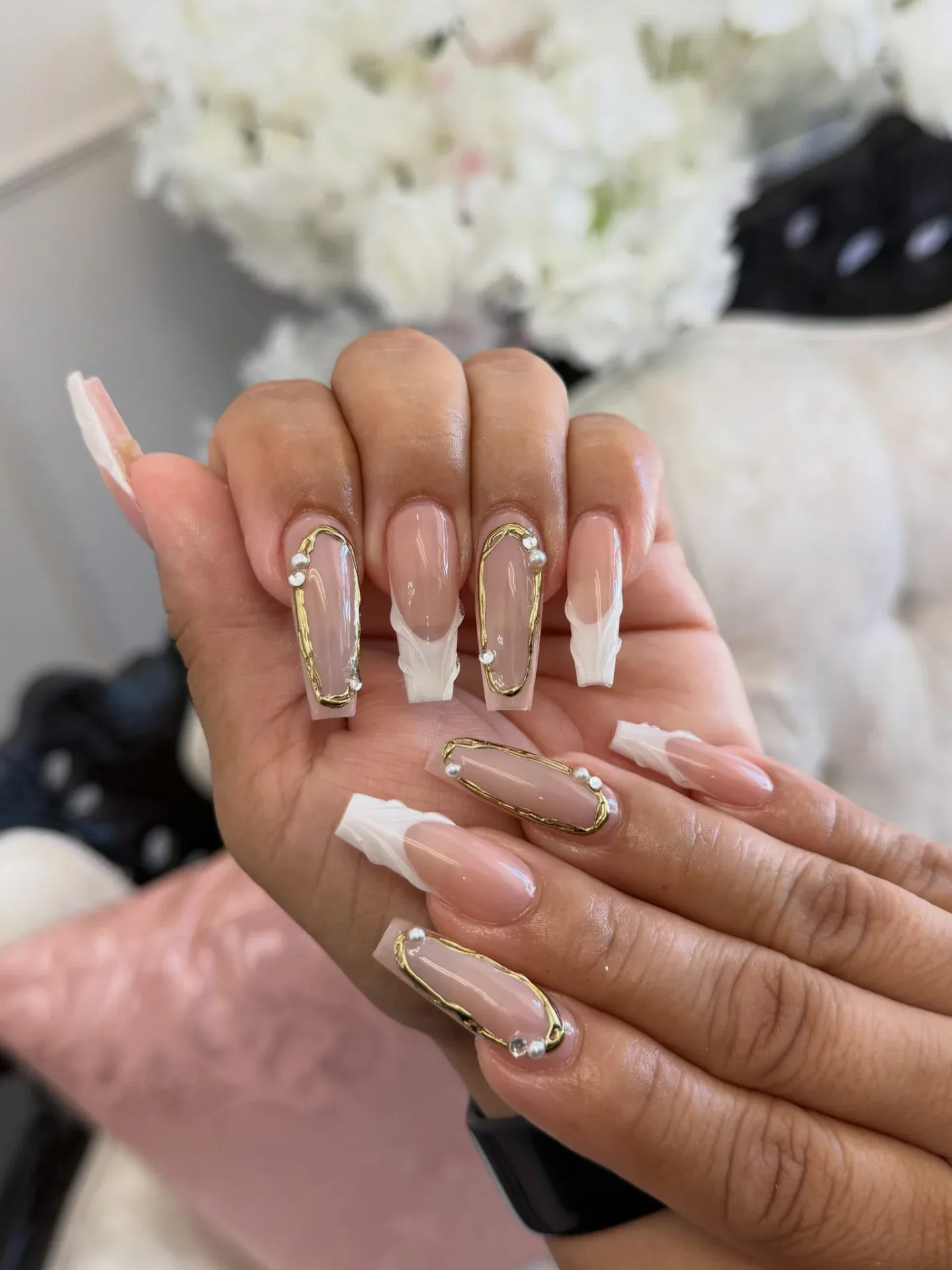 Elegant nude nails with gold details and pearls