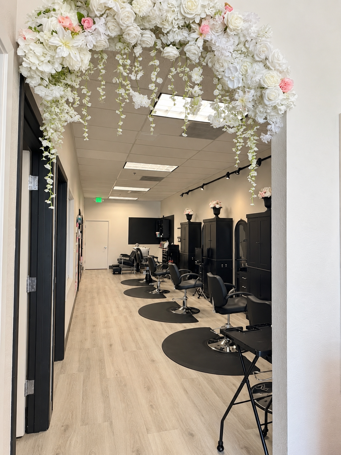 GioBBeauty salon interior with floral archway and styling stations