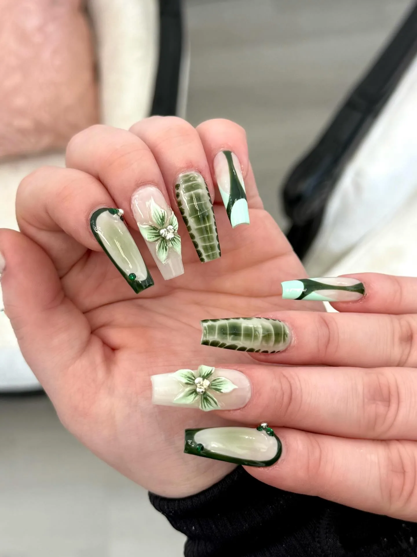 Green nail art with floral and croc details